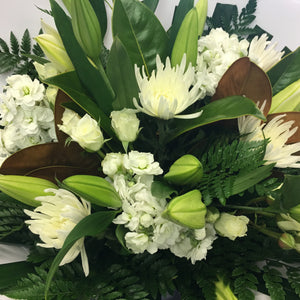 Wellington Flower Co. bouquet of greens and whites. This bunch has a mix of lilies, magnolia, chrysanthemum, stock, spray roses and leather fern